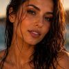 A close-up of a woman with wet hair, radiant skin, and a peaceful expression, glistening under soft sunlight.
